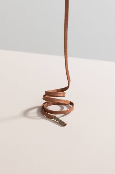 shoelace, shoe string, leather shoelace, replacement laces, shoe accessories, product demo, minimalist, calm, trustworthy, brown, neutral